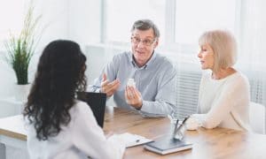 Mature couple asking their doctor about medicine