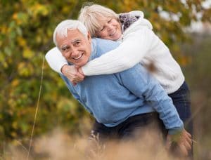 Image of elderly couple embracing 