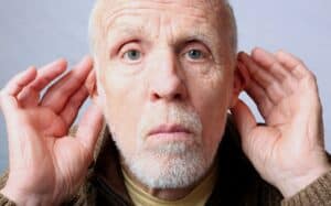image of elderly man experiencing hearing loss  