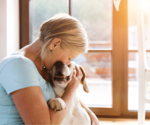 senior woman hugging dog