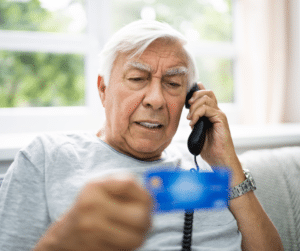senior baby boomer man with credit card upset after fraud