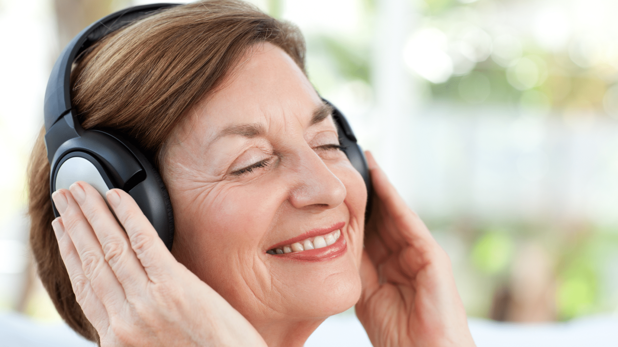 senior listening to music on headphones