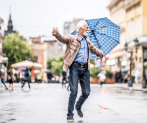 senior man in rain with umbrella
