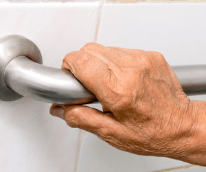 seniors hand on a grab bar bathroom safety