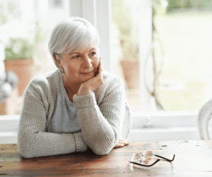 older woman baby boomer in home at kitchen table