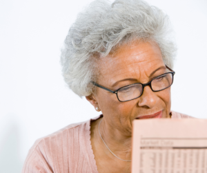 senior black woman reading newspaper