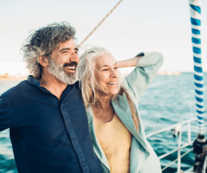 senior couple on a sailboat windy day