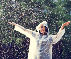 adult woman in raincoat in rain cheerful resilient