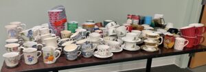 table with mugs and cans
