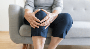 woman holding knee for joint pain