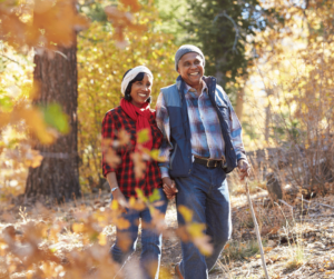 black couple walking in fall woods